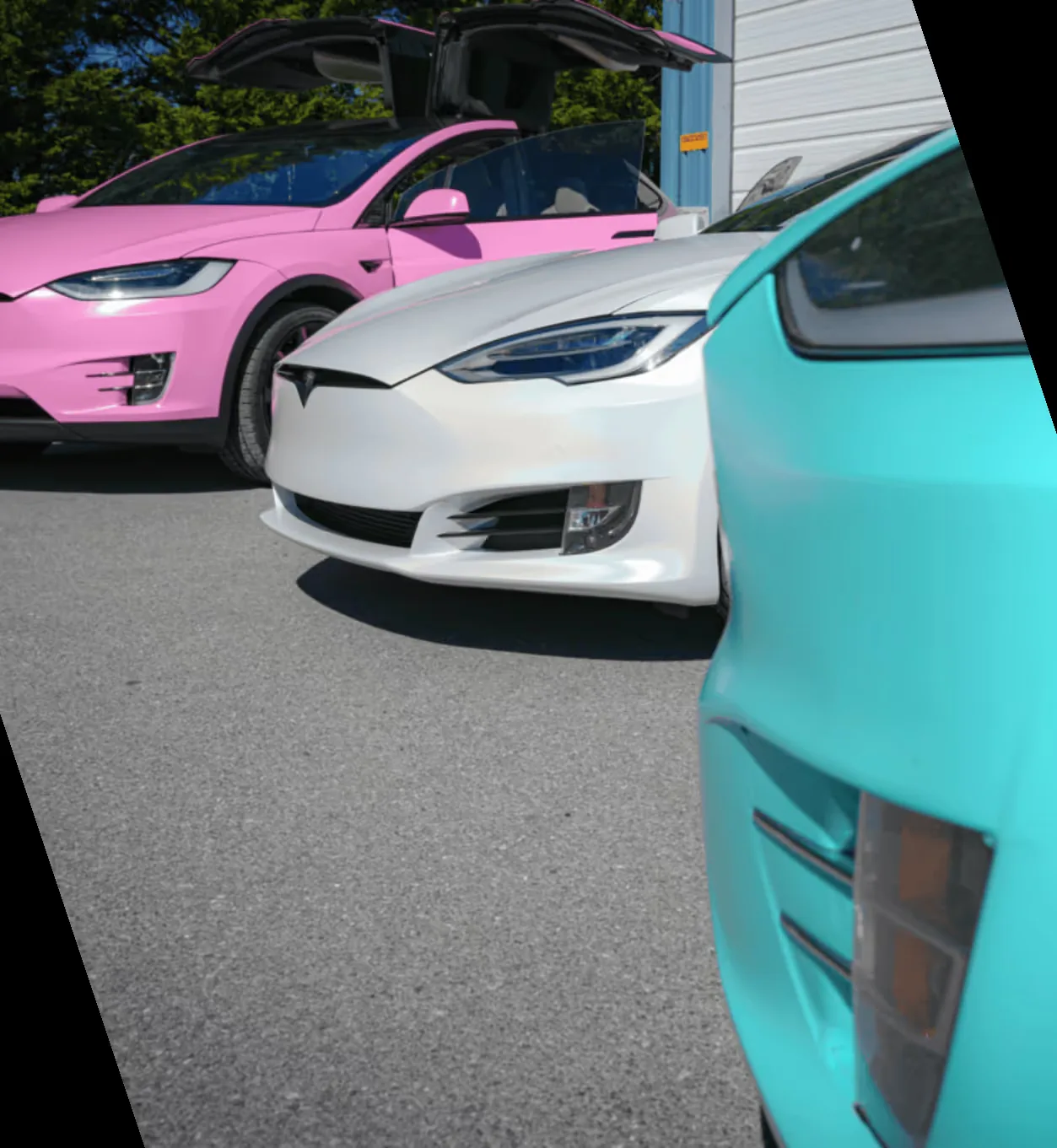 Three wrapped Teslas outside the SpaceShip Wraps install bay